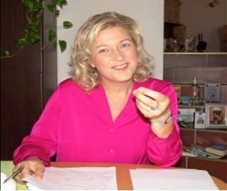 Porträtfoto von Frau Dr. Claudia Possardt am Schreibtisch sitzend.